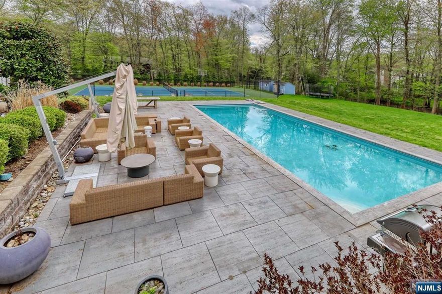 Looking for a "Resort-Like" property? Your search has ended... Enjoy your private in-ground pool, tennis court and a beautiful CONTEMPORARY HOME on 1.22acre of LUSH property nestled in Norwood NJ, only minutes form NYC. This home HAS BEEN GUTTED DOWN TO FRAME AND SUBFLOORS! MOST PRIVATE in-ground GORGEOUS POOL (45/20 feet), FULL SIZE TENNIS COURT ,HUGE DECK, A PATIO,and a GYM ! Relax in a beautiful home nestled in Norwood NJ, only minute form NYC. This SLEEK MOST MODERN HOME has been totally renovated including subfloors ! Home offers A BEAUTIFUL PRINCIPLE SUITE , additional 4 bedrooms and 3..5 MOST EXQUISITE BATHROOMS ! MOST INVITING GORGEOUS DESIGNER KITCHEN LEADING INTO A VAST DECK , PERFECT FOR A "Country Club" STYLE ENTERTAINMENT .... Overlooking SHOW STOPPER POOL & TENNIS COURT. Make it yours! FLOOR PLANS ARE AVAILABLE.