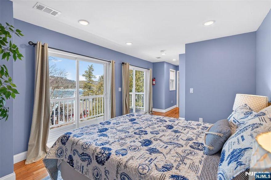 Perched high above Lake Mohawk on coveted Birch Parkway, this nearly new home enjoys sweeping lake views from one of the most desirable vantage points in the community. From its elevated position across from the shoreline, the home captures panoramic views of the water while offering a sense of privacy rarely found so close to the lake. The home features a bright, open interior oriented toward the lake views and a spacious deck that provides the perfect setting for relaxing or entertaining while overlooking the water. Recently completed construction includes major system upgrades such as a new septic system, new HVAC system w central air and heat, tankless water heater, updated flooring, renovated kitchen and modern bathrooms, offering peace of mind with many of the home's major systems already completed. Birch Parkway is widely considered one of the most desirable addresses in the Lake Mohawk community, known for its dramatic lake views and proximity to the shoreline. The property carries a Sparta mailing address but is located in Byram Township, a unique distinction along this section of Birch Parkway where homes share membership in the Lake Mohawk community. Ownership includes membership in Lake Mohawk Country Club, providing access to private beaches, boating, fishing, community events and the iconic boardwalk area. Ideal as a full-time residence or peaceful weekend retreat, opportunities to own a lake-view home in this location rarely become available.