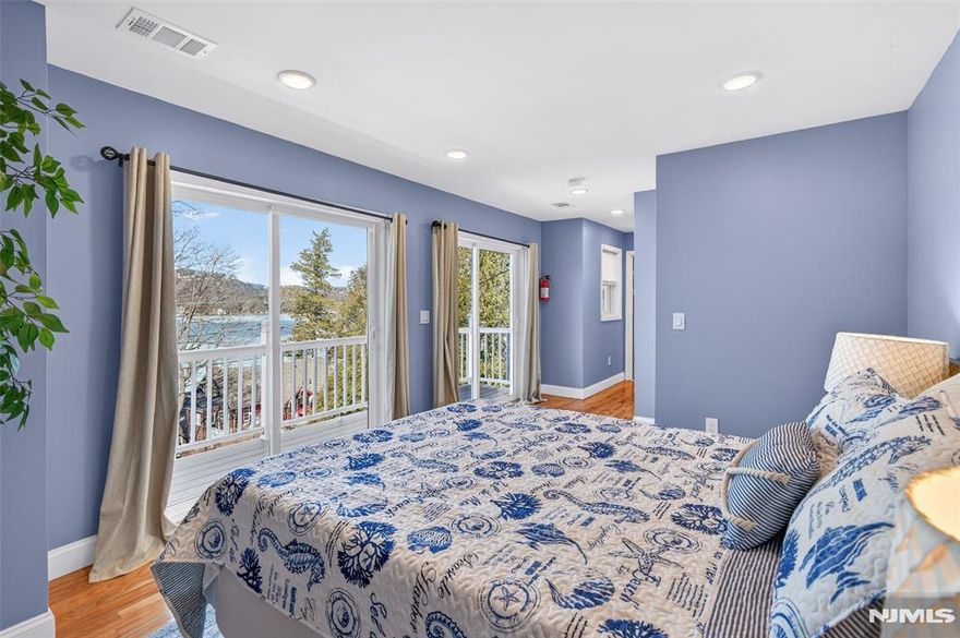 Perched high above Lake Mohawk on coveted Birch Parkway, this nearly new home enjoys sweeping lake views from one of the most desirable vantage points in the community. From its elevated position across from the shoreline, the home captures panoramic views of the water while offering a sense of privacy rarely found so close to the lake. The home features a bright, open interior oriented toward the lake views and a spacious deck that provides the perfect setting for relaxing or entertaining while overlooking the water. Recently completed construction includes major system upgrades such as a new septic system, new HVAC system w central air and heat, tankless water heater, updated flooring, renovated kitchen and modern bathrooms, offering peace of mind with many of the home's major systems already completed. Birch Parkway is widely considered one of the most desirable addresses in the Lake Mohawk community, known for its dramatic lake views and proximity to the shoreline. The property carries a Sparta mailing address but is located in Byram Township, a unique distinction along this section of Birch Parkway where homes share membership in the Lake Mohawk community. Ownership includes membership in Lake Mohawk Country Club, providing access to private beaches, boating, fishing, community events and the iconic boardwalk area. Ideal as a full-time residence or peaceful weekend retreat, opportunities to own a lake-view home in this location rarely become available.