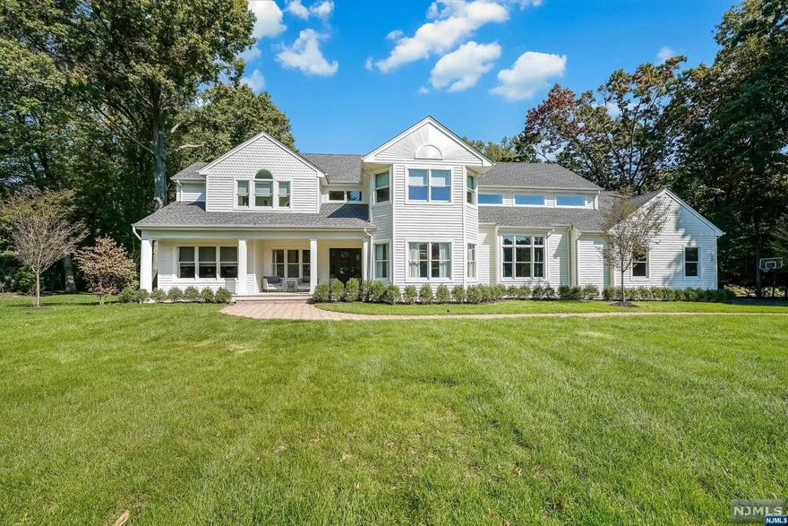 This stunning, completely redesigned 5 bedroom and 4.5 bath home offers 4,800 sq ft of modern open concept living space & over 1 acre of property. The first level is complete w/ a 2 story EF, powder room, formal LR w/ SGD to backyard and Trex decking, custom home office w/ built ins, large all new MEIK feat. wet bar/coffee station, large quartz island, SS appliances, and custom butler's pantry. Formal DR, large mudroom, laundry room, WIC/pantry, guest suite with dual entrance and all new updated full bath. Second level boasts large primary bedroom w/ tray ceiling, 2 custom WICS, & luxury spa like primary bath complete w/ marble flooring, dual sinks & soaking tub. Ensuite bedroom w/ WIC & updated full bath, large 3rd bedroom w/ custom closet & dual entrance to new full bath. Loft/rec room, and brand new large laundry room with tons of storage. Extra storage and utilities on ground level. Amazing outdoor space for entertaining. Close to all NYC transit & Blue Ribbon schools.