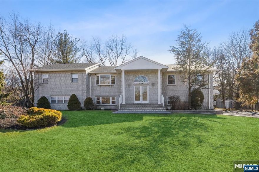 This spacious and well-maintained 4-bedroom, 4-bathroom home offers over 3,000 sq ft of living space in the heart of Franklin Lakes. The first floor features a welcoming family room with a fireplace and built-in bar, a versatile bonus room, full bathroom, laundry room, and an attached 2-car garage. Upstairs, enjoy an open-concept living room and kitchen with access to the deck - ideal for entertaining. The luxurious primary suite includes a gas fireplace, walk-in closet, and a large en-suite bathroom with soaking tub and separate shower. Three additional bedrooms and two more full bathrooms complete the second floor. Step outside to a private backyard with a spacious deck, in-ground pool, and large fenced yard. Located in a highly desirable neighborhood close to top-rated schools, parks, and amenities.