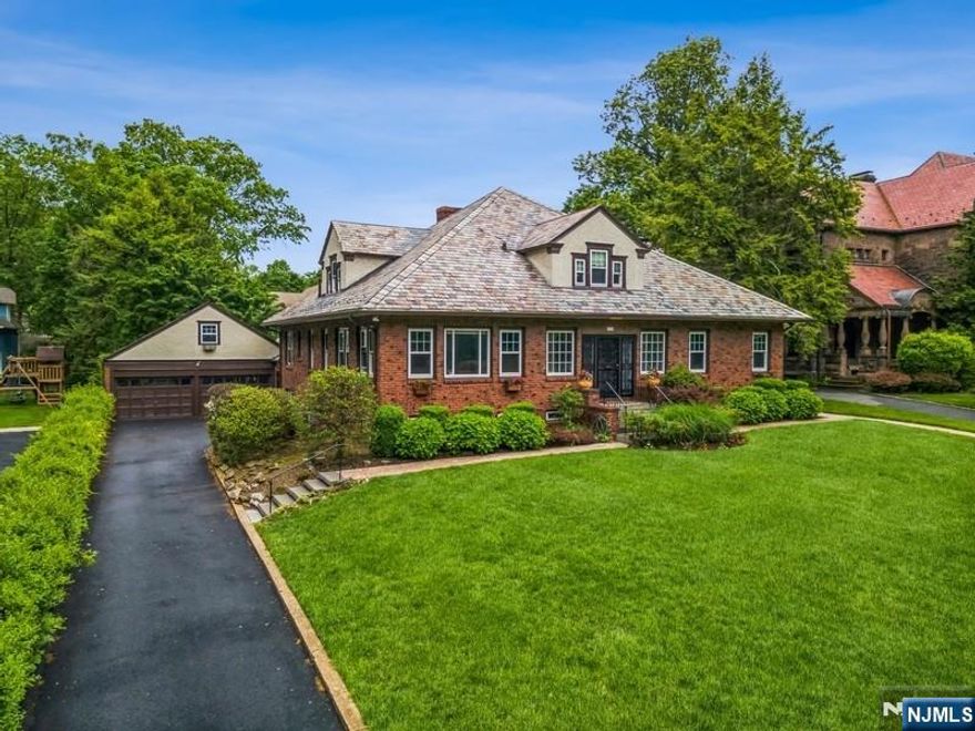 Step into a property that's truly in a class of its own. This all-brick, stand-alone classic blends craftsmanship with undeniable character. From its hand-laid brick exterior to its central living room layout, this distinctive property offers five bedrooms and five bathrooms, arranged within a flexible floor plan. Additional highlights include a spacious second-floor great room, two fireplaces, radiant heat bath/floors, hardwood floors throughout and charming period details. The expansive basement/lower level features an original wet bar, a recreation room, and several versatile spaces suitable for a variety of uses. Modern updates include central air conditioning, a brand-new heating system, security & fire alarm system and updated windows throughout the home. The property also features a two-car garage with a full loft. The ultra-private backyard offers a dedicated sports court and ample space to design your own custom outdoor retreat. Easy location in a charming, historic, gas lamp-lit town just a few blocks from direct train service to NYC and top-rated schools.