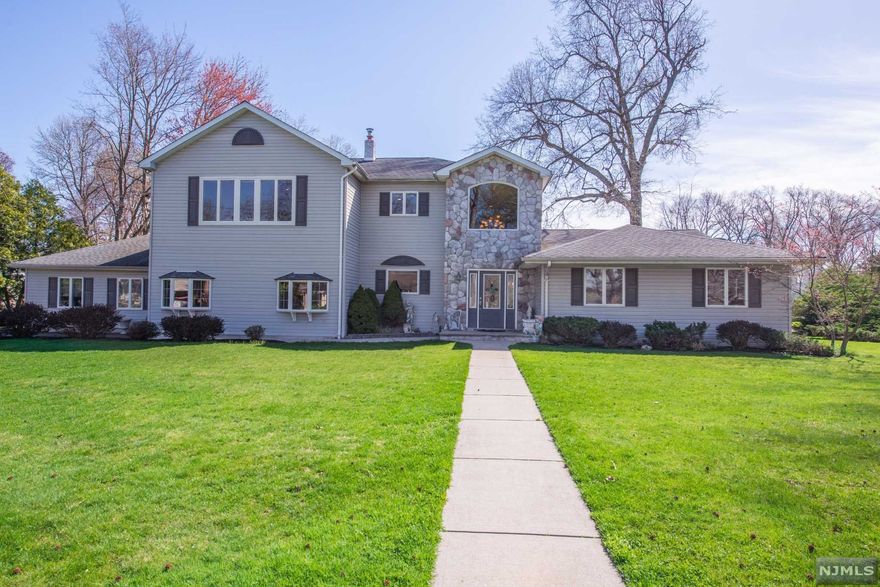 Highlighted by an iconic flowering pink dogwood, this home sits on almost an acre of property on a quiet cul-de-sac. Enter through the two story foyer and notice all the upgrades the owner has lovingly put into place. Gleaming hardwood floors in dining room with large bay window, will have you ready to entertain. Newer eat-in kitchen with custom cabinets, s/s appliances and granite counters. Florida room looks over the huge vinyl fenced in yard with gunite pool, hot tub (staying) and two out buildings. Large family room with tray ceiling, granite gas fireplace, wet bar, and doors out to yard. Separate multi-purpose rec. room with full bath, Cabana type entrance from pool to full bath & changing room. 3 bedrooms down with one of two master suites. Upstairs includes 1 bedroom and 2nd HUGE (27 x 22) master bedroom suite with bidet, Jacuzzi tub and two walk-in closets with changing area. New C/A 2011, Roof 2003, Sprinklers 2011.