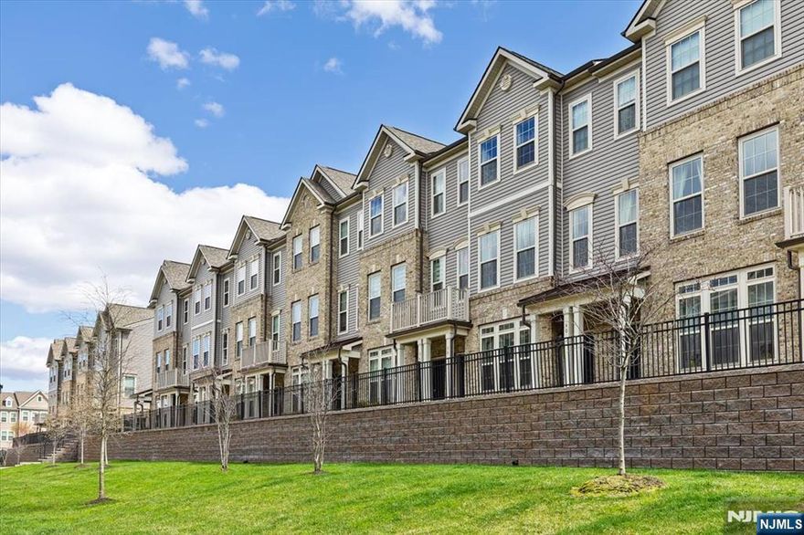 Bright and modern 2 bedroom, 2 full bath townhome offering a move in ready layout in a highly convenient location. This well maintained unit features two levels of living space, including a contemporary kitchen with custom cabinetry, granite countertops, and energy-efficient stainless steel appliances. Waterproof luxury vinyl flooring throughout the main level adds both style and durability. The second floor offers two generously sized bedrooms, an oversized full bath with double sinks, and a full-size washer and dryer for added convenience. Additional highlights include an attached garage, driveway parking, and ample guest parking. Ideally situated near NJ Transit train service, parks, shopping, gyms, supermarkets, and major highways, making commuting to NYC simple and accessible. A great opportunity for comfortable, low-maintenance living in a commuter-friendly location.