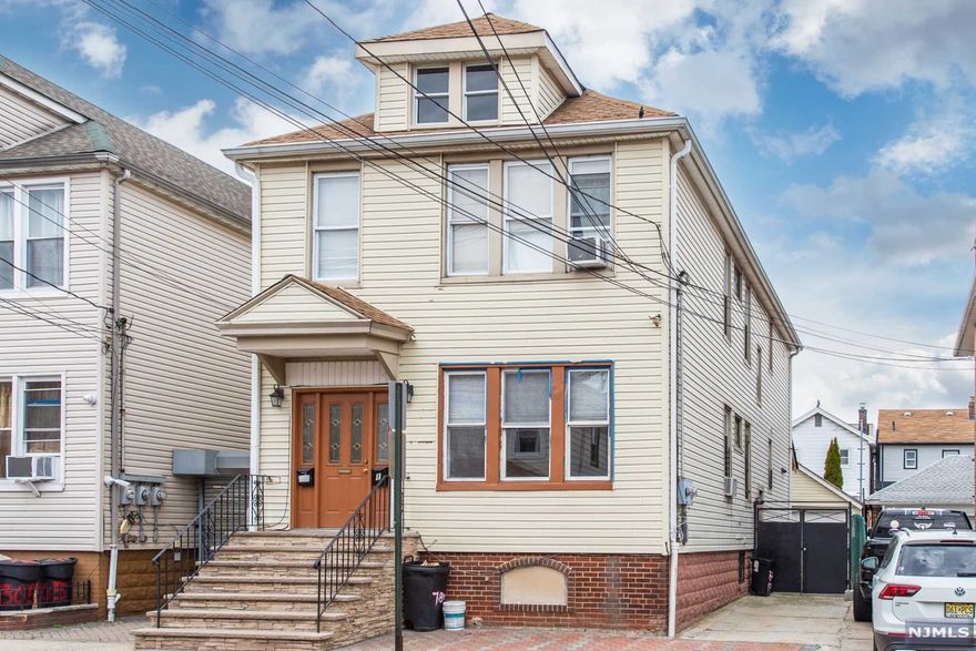 Looking for a large two-family home close to NYC, you found it! This extra-large two-family home is located in the beautiful racetrack area of North Bergen. This beauty features two large apartments with a full finished basement ideal for an extended family. First floor features an inviting living room, dining room, two bedrooms with plenty closet space and a full bathroom, modern kitchen with direct backyard access. Second floor features a large living room, 3 bedrooms with plenty closet space, full bathroom and renovated kitchen. Side and front entrance.Full finished basement with several rooms and a renovated bathroom.Two car driveway plus a large two car garage, with attic space for extra storage. Totally paved backyard and sidewalk (no more cutting grass on weekends, just enjoy the patio!) Plus, separate utilities, separate heating and water heaters. Close to to NYC Transportation, shopping and the amazing James Braddock Park. Low taxes. Too many amenities to list!Call today!