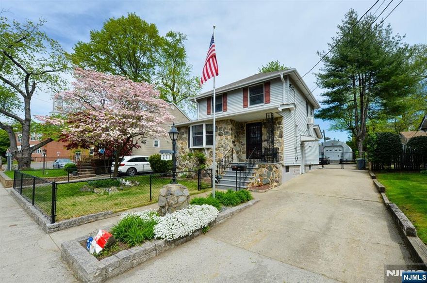 A true clean and classic colonial! Huge living room with wood beams and beautiful hardwood floors. Nice open concept first floor. Dining room with sliding glass door to covered deck with hot tub! Large kitchen with breakfast bar. Half bath on first floor. Second floor features 3 nicely sized bedrooms with great closet space, and full bathroom. Finished basement with half bath, laundry and loads of storage space. Enjoy the lovely fenced rear yard. Oversized detached one car garage. Plenty of driveway parking! Convenient location, walk to NYC transportation, schools and shopping! A must see to appreciate this lovely move in ready home!