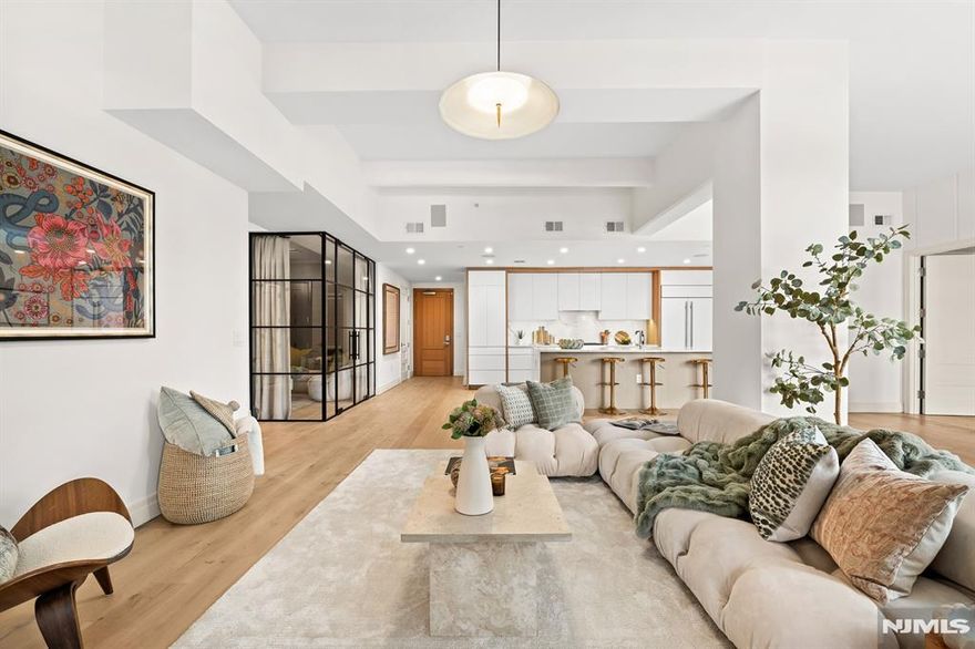 A rare offering at the iconic Wonder Lofts, this expansive 2,456 sq ft, 3-bedroom + den, 3.5-bath home blends authentic loft character with elevated, designer finishes. Reimagined by Joan Enger of J. Patryce Design & Co., Residence 508 showcases exposed brick, steel beams, and concrete columns paired with refined, custom interiors. A thoughtfully designed entry features a built-in mudroom, leading to an open-concept living and dining area ideal for modern living. The chefâ€™s kitchen is equipped with Calacatta Lava countertops, a waterfall island, custom cabinetry, and premium appliances including Sub-Zero, Wolf, and Bosch. A versatile, enclosed alcove with glass-and-steel detailing serves as a perfect office, family room, or guest suite with its own bath. The primary suite offers a custom walk-in closet and spa-like bath with Italian marble, soaking tub, and glass shower. Two additional bedrooms are spacious with beautifully finished baths. Additional highlights include custom millwork, European oak floors, smart home features, Sonos sound, in-unit laundry, and a 212 sq ft private terrace. Includes deeded parking and storage. Residents enjoy 14,000+ sq ft of amenities, including a rooftop pool, fitness center, and lounge. Near Manhattan via ferry, PATH, and NJ Transit.