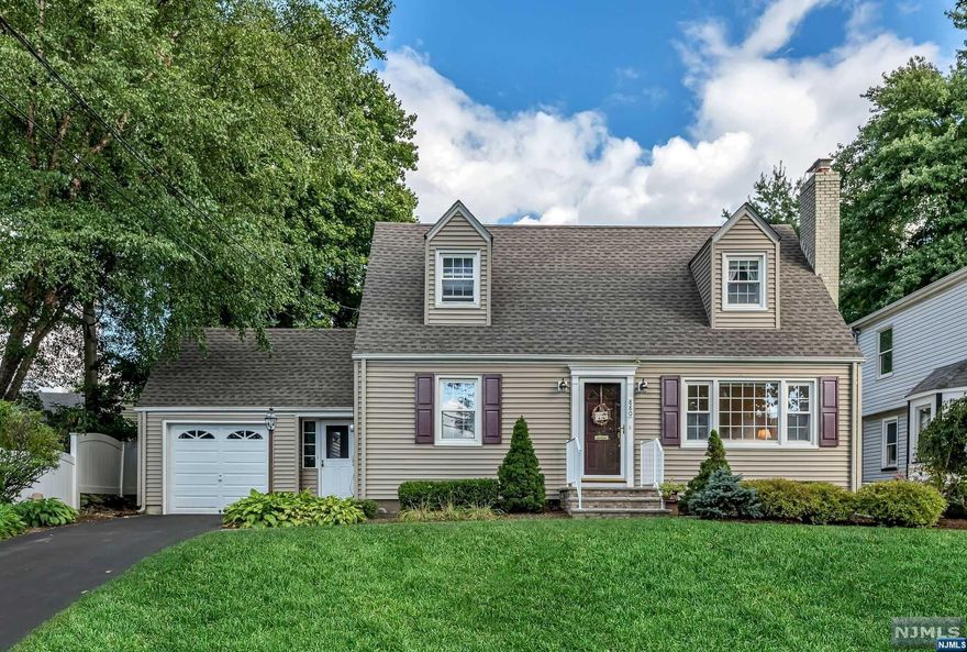 An expanded Colonial Cape w/ many important updates. Beautifully landscaped w/inviting curb appeal and impeccable masonry. Large bright LR has handsome fireplace and opens to Den and first floor Primary Bedroom w/ensuite. Circular flow to open concept Kitchen / DR. Lots of counterspace w/ some newer appliances. Breezeway w/ entrance to driveway, garage, patio & kitchen. Powder room perfectly located off the Den. Center staircase is set back and leads to 2nd primary BR and 2 additional BRs w/ higher ceiling. Spacious hallway w/2 closets and full bath. Hardwood under carpeted rooms. The basement is nice sized and ready to finish. Very private manicured yard. Roof ('21), water heater ('22), driveway, walkways, steps ('15) HVAC ('13). Updated electric and tilt in replacement windows. Leave your car behind for all 3 schools, Memorial Park, and train/bus to NYC. This home has a fantastic floor plan and is just a few cosmetic upgrades away from fabulous. Let your River Edge story begin!