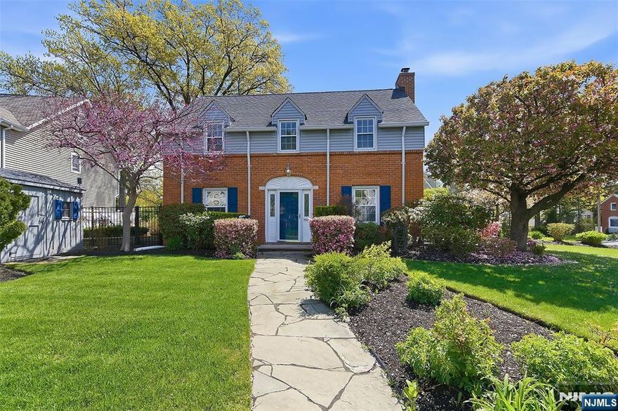 Stately and elegant brick Colonial home in one of central Bergen County's most idyllic neighborhoods! Tucked away in the immensely charming "Knolls" area, yet just steps to express NYC trans, this beautiful home was completely rebuilt in 2007 with the utmost care and quality. The inviting interior welcomes you in with a formal entry foyer flanked by archways leading to a spacious front to back living room w/fireplace and built-in bookcases and a separate formal dining room. Off the DR you will find the gorgeous kitchen with high end appliances, including a built-in fridge & double wall ovens, and honed granite counters. The sun-filled breakfast rm off the kit opens to an impressive family room with vaulted ceilings and a full bathroom (easily converted to first flr BR suite). Three spacious BRsw/custom closets and a full bathroom are on second floor. Fully finished basement offers great add'l living pace & tons of storage. Access to the fully fenced courtyard gardens with bluestone patios & perennial plantings can found off of the breakfast rm, LR and fam room. Gleaming hardwood floors throughout, cent air (2025), whole house generator, in-ground sprinklers, 200 AMP elec and much more. Fantastic location in this tree lined private neighborhood is steps to express NYC transportation, close to local shopping and dining and easily accessible to all major highways. With its perfect blend of classic architecture, timeless design and modern updates, this home is not to be missed!