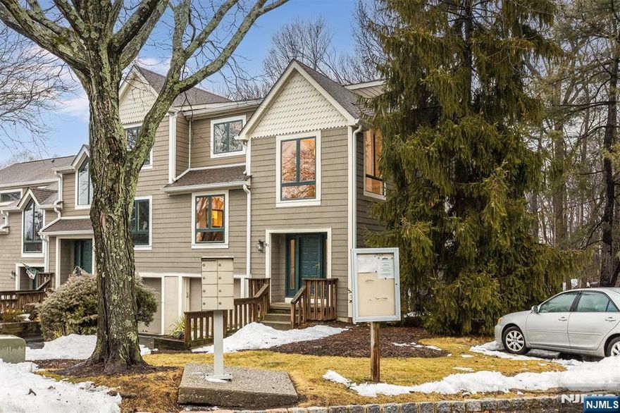 One of the most desirable layouts in Glen Pond, this end-unit townhome offers the second largest floorplan in the community with over 2,100 sq ft across three full levels. Bright and airy with an extra wall of windows, natural light pours into every level of this lovingly maintained home. The main floor features expansive living and dining spaces, a welcoming family room with cozy two-sided fireplace, and sliding doors to a private deck overlooking a peaceful wooded setting ideal for entertaining or quiet mornings outdoors. The kitchen features double wall ovens, granite countertops, tile backsplash and a peninsula with seating. Upstairs, the top level includes three bedrooms and two full baths. The spacious primary suite boasts a large bedroom, dressing area with vanity, a private bath complete with skylit shower and soaking tub as well as a WIC and 3 additional closets. The finished lower level offers exceptional flexibility with a full bath, office/bedroom with WIC and sliding doors providing exterior access -- perfect layout for guests or home office. New roof in 2023, central air, generous room sizes, and easy townhouse living in a prime location near Routes 3, 46, 23, 80 and the GSP with plentiful shopping, dining, and NYC transportation options.