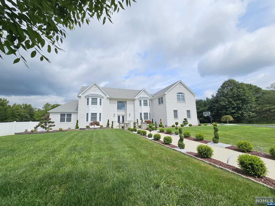 Welcome to 19 Adam Ct in Monroe Township, a luxurious contemporary home at the end of a quiet cul-de-sac on 2.5 acres of beautifully maintained land. This 6-bedroom, 5-bathroom residence is the epitome of high-end living, with every detail thoughtfully designed. Lower Level: The walkout basement, filled with natural light, includes a spacious bedroom, a full bathroom, a modern kitchen with an eating nook, a living room, workout area, bar, and a state-of-the-art movie theater with starry ceiling lights and surround sound. First Floor: The large kitchen with a breakfast bar opens to a formal dining room. This floor also features a second bedroom, a full bathroom, a 2-story family room, an office, and a sunroom. Second Floor: The Master suite offers a spacious bedroom, sitting room/office, and an oversized bathroom with a chandelier and free-standing tub. Outdoor Oasis: The outdoor space includes an indoor pool, jacuzzi, soccer field, playground, LEDs & string lights