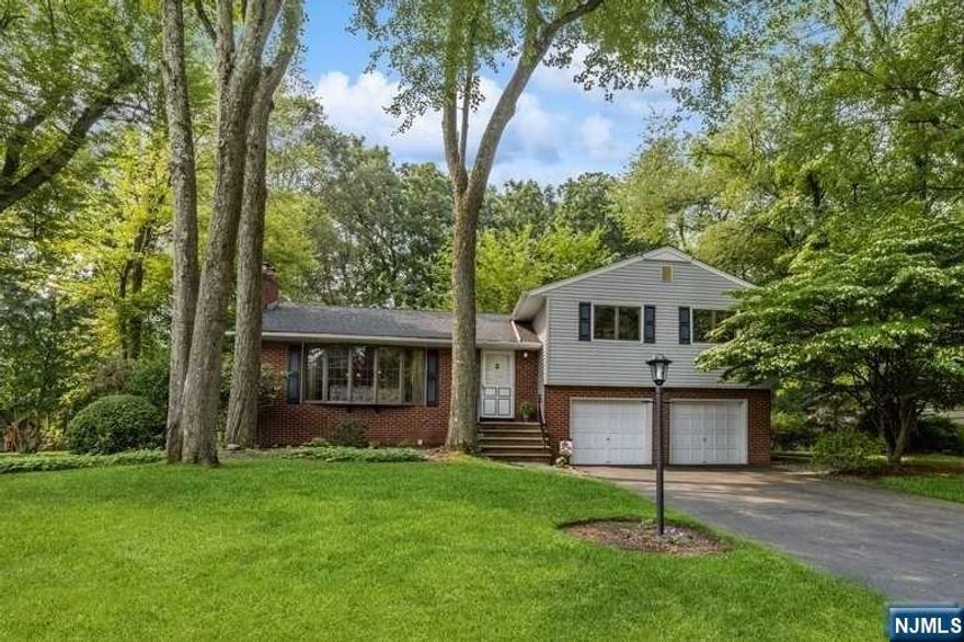 Prime Location! This Split Level home sits on a deep lot. Nicely landscaped with mature flowering trees. The welcoming foyer leads you to the spacious living room, complete with a brick fireplace, built-in shelving, and an impressive Bay window that floods the home with light. Hardwood floors are throughout most of the home. The nice size family room has a vaulted ceiling, sky lights, and lots of windows that bring the outside in. Sliding door leads you to the shaded deck and large backyard which is perfect for entertaining family and friends. Three generous size bedrooms and an gym/office space complete this great home. Home is being sold as-is. Centrally located in the highly desirable town of River Vale and Top-Rated School District! Close to Parks, Shopping, Restaurants, Golf Courses and Transportation into NYC. Palisades Parkway access is only a few miles away.