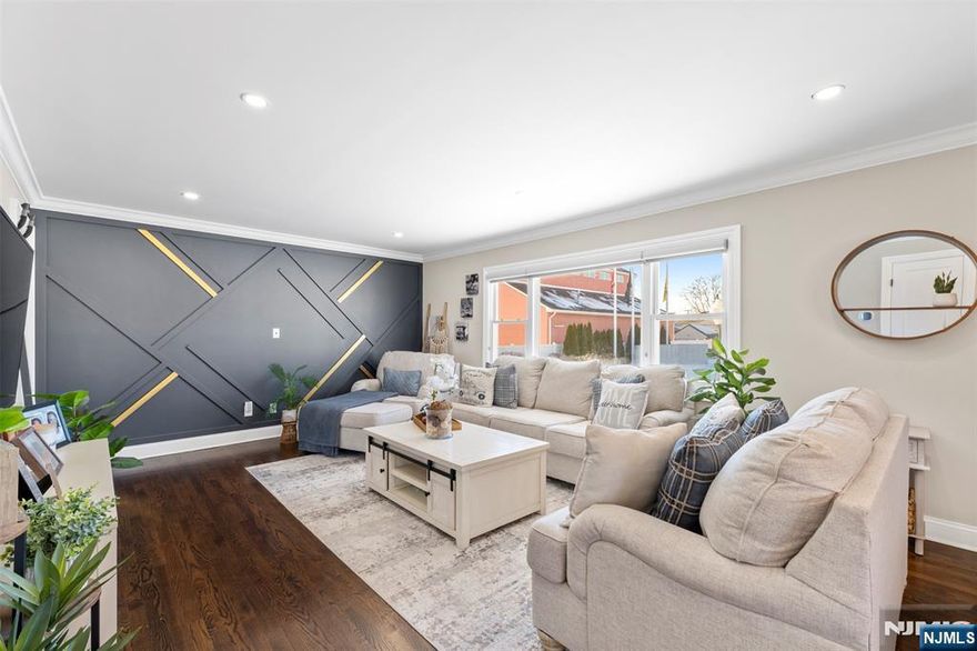 Beautifully renovated in 2022, this move in ready home in Lodi offers a refined, modern aesthetic with every major upgrade already completed. The immaculate kitchen features sleek quartz countertops, stainless steel appliances, recessed lighting, and a breakfast bar area perfect for barstool seating, flowing seamlessly into a sun filled living room and a spacious dining area with ample room for a full sized dining table, ideal for entertaining. Generously sized bedrooms include a primary suite that easily fits a king sized bed, while the fully renovated basement with LVP flooring provides additional living space, washer and dryer, a large utility room, and abundant storage. Major updates include a newer furnace and central air system under two years old, a new roof, and a newly paved driveway. Enjoy a large private deck and backyard with no neighbor on the right side for added privacy, all in a prime location with quick access to New York City, offering an elegant, luxury feel without the need for any renovations.