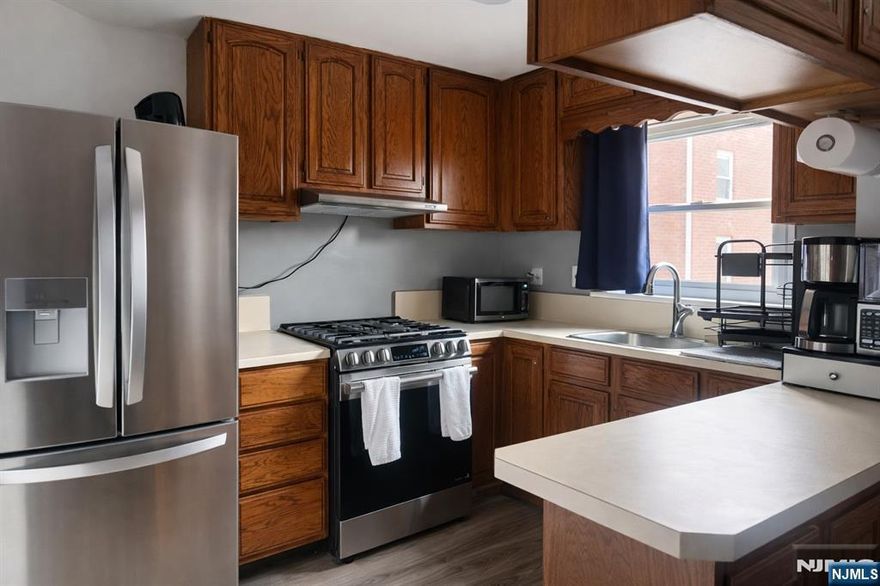 Welcome to this beautifully maintained and move-in-ready condo located in the desirable Maple Hill section near the Maywood border. This bright and inviting unit features a spacious kitchen with ample cabinetry and counter space, seamlessly flowing into a dedicated dining areaâ€”perfect for everyday living and entertaining. The updated bathroom offers clean, modern finishes, while the well-proportioned living and bedroom spaces provide comfort and flexibility, including room for a home office. Hardwood floors and abundant natural light enhance the warm, welcoming atmosphere throughout. Set within a serene, park-like community, this pet-friendly residence offers both privacy and convenience. Commuters will love the NYC express bus located directly across the street, along with easy access to local and GWB routes, major highways, shopping centers, and downtown Maywood. Just minutes from schools, malls, and Hackensack University Medical Center, this location delivers exceptional lifestyle value. Maintenance includes heat, hot and cold water, and parkingâ€”making ownership both affordable and hassle-free. Donâ€™t miss this opportunity to own in one of Hackensackâ€™s most convenient and sought-after communities!