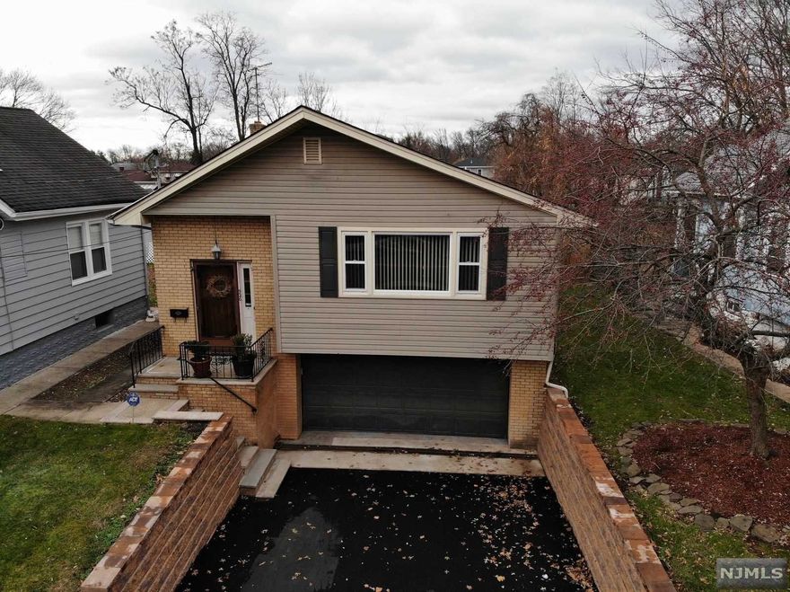 Beautiful very deep property 51x233 spacious raised ranch style of a home built in 1981. This home features an open concept living rm and dining rm w/ hardwood flooring 2 BRs, 1 bath, EIK, season room over looking a DEEP fenced in yard on the 1st flr. On the ground flr, there is ample living rm with full bath, laundry rm, utility rm, separate entrance to private yard. This GEM of a home has sprinklers, solar panels, central air, forced hot air, 10 yr roof, new boiler, ew retaining wall in attached driveway with new asphalt that fits 6+ cars. Walking distance to an AMAZING park .