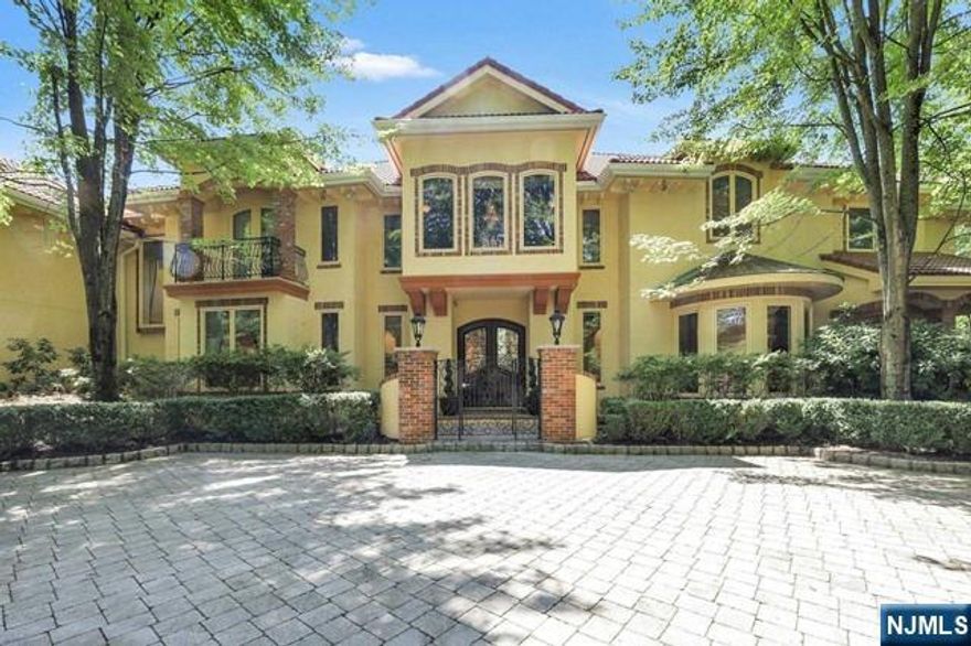 Nestled in one of Demarest's most coveted locations, this extraordinary estate exudes sophistication and set on 1.19 acres. The wrought iron front doors open to a breathtaking foyer, complete with an art gallery. The open-concept custom kitchen boasts bespoke cabinetry, granite countertops, a butler's pantry, and spacious eat-in area with a vaulted ceiling. The family room features a fireplace and French doors leading to the pool with spa, while the formal living and dining room are complemented by oversized windows overlooking the front yard. The main floor has soaring 12-foot ceilings, stunning hardwood flooring, a rear staircase, and elegant bathrooms. The second floor houses a luxurious primary bedroom suite with five rooms, along with three additional bedrooms, a large laundry room, and a playroom. The fully finished lower level includes a gym, a vast playroom, a bedroom, a changing room, and a full bath. The property is securely fenced with electric front gates. A must see!