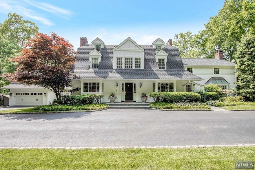 DECEPTIVELY LARGE W/ 6,245 Int.Sqft w/o basement! Reside on over 1/2 Acre in the famous Old Smith Village, on Tenafly's sought after East Hill. Privacy & timeless design are complemented by modern amenities like radiant heat, home office, generator & 2 story GYM (playrm). A gourmet kitchen boasts Viking & Sub-Zero appl, butler's Pntry, warming&refrig drawers, 3 sinks & glass surround eat-in bfast area. Host w/ease in the gracious living areas highlighting oversized fireplaces, wet bar, bay windows & beautiful wood floors. A luxurious Primary Suite w/his/her bath & shared shower ft 2 WICs & balcony.2 spacious Ensuite bed/baths + bdrm/den complete the 2nd flr.3rd flr has 2 add.Ensuite Bed/Baths. The LL boasts full living quarters w/private entrance, renovated Bth & large rec space.Entertain alfresco in the lush backyard w/stone built-in BBQ, deck, covered pergola & generous blue stone patio. Don't miss this 1-of-a-kind estate,6 miles to GWB & Tenafly's highly rated public schools.