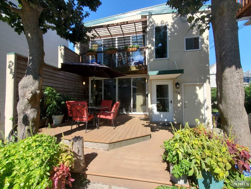 Beautiful custom designed house was rebuilt in 2007-08 features magnificent elements such as Brazilian Ipe wood privacy wall extends from the exterior into the house on both floors. On 1st fl. spacious open floor plan w/ bright living rm, dining rm, kitchen w/ SS appliances, granite countertop & new floor as well as BD w/ a shower for greater accessibility. More on 1st fl. Hardwood floors & recessed lighting throughout & Custom 13 ft sliding glass doors invite to a private outdoor area. Hardwood tread staircase full of light fm oversized windows leads to upper level. 2nd fl. w/ hardwood floors throughout & ceiling fans in all bedrooms, features contemporary main BD oasis w/ high vaulted ceiling, Brazilian Ipe wood wall & exclusive deck & veranda. More on 2nd fl. 2 other BD's & a BA. New heating & central a/c, house freshly painted, & off st. 4 cars parking complete this home. Perfect location, a block from Blvd East, near stores, parks & easy NYC commute.