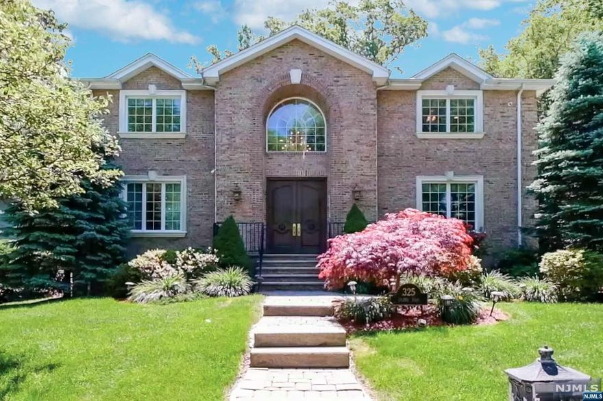 Welcome to this stunning Classic Brick Colonial, situated on a beautifully landscaped property on a quiet street that is conveniently located near NYC transportation. The home was custom-built in 2006 featuring large bright rooms, cherry hardwood flooring, crown moldings, three fireplaces, radiant heat, and numerous quality features. The Main Level boasts oversized rooms, 9-foot ceilings and radiant heat under all tile. The Gourmet Kitchen is adjacent to a Family Room with a fireplace that exits to the private rear yard. An oversized Living Room, Dining Room, Office and Powder Room complete this level. The Second Level is comprised of five Bedrooms and four Bathrooms including a well-appointed Primary Bedroom Suite. The Finished Basement is fully tiled with windows and includes an open Recreation area, Bedroom, Full Bathroom and a Mudroom that exits to a 3 Car Garage. The rear property has a large patio and an outdoor fireplace, perfect for entertaining!!