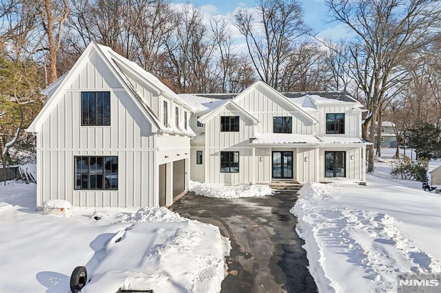 Set within Closterâ€™s prestigious East Hill enclave, this newly constructed 9,250 SF estate blends natural stone and Hardie®-panel siding with a refined contemporary design. Offering over 3,700 SF on the main level alone and 10-foot ceilings throughout, the home delivers exceptional scale, craftsmanship, and seamless indoor-outdoor living. A dramatic two-story foyer introduces white oak flooring, a floating staircase, formal dining with butlerâ€™s pantry, formal living, and an expansive family room with Venetian plaster fireplace wall. The Modiani-designed kitchen features custom cabinetry, quartz surfaces, a 10-foot island, and full Thermador appliances. Sliding glass doors open to a covered patio and resort-style 14x30 pool with outdoor kitchen. The upper level includes a private primary suite with terrace, boutique-style closet, and spa bath with radiant heat, plus three additional en-suite bedrooms and a loft. The finished lower level offers a gym, theater, recreation room with wet bar, guest suite, and full bath. Additional highlights include a 3-car garage (lift-ready), 300 AMP service, full-house generator, multi-zone HVAC, radiant heated baths, smart home integration, security system, Andersen 400 windows, and premium finishes throughout. Located within the Northern Valleyâ€™s top-rated Blue Ribbon school district, just a short walk to the elementary school and the renowned Closter Plaza, this home offers both luxury and convenience in this amazing community!