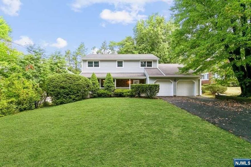 Amazing Price - Search No More!! Beautiful, totally updated four bedroom home set on a gorgeous private lot on the much sought-after East Hill in Tenafly, a stone's throw to downtown, Blue Ribbon schools, houses of worship and NYC transportation. A warm and welcoming front porch and an entry to the family room with wood burning fireplace and overlooking the park like, flat property provides an excellent flow throughout the home. With hardwood floors through, first floor also offers a formal living room, formal dining room, renovated eat-in kitchen with new appliances, newly renovated powder room and access to the newly renovated two-car garage. Large Primary Suite, an additional three bedrooms and a full hall bath complete the second floor. Fully finished lower level with rec area, office and storage. Additional features are the new roof and siding, full house generator and very low taxes - A Must See!!