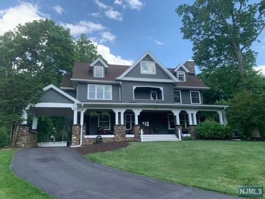 Renovated to perfection, this gorgeous colonial home is an iconic representation of the romance of the 1920's era, all while boasting the convenience of modern living! Up the winding drive to the stone pillared carport & past an expansive covered front porch, visitors are greeted by a spacious foyer, high ceilings & public space - living room w/ gas fireplace, sun-filled dining room w/ sliders to the deck. Ideal for all holiday gatherings, the jaw-dropping eat-in kitchen features breakfast nook, plenty of cabinetry, quartz counters, high end stainless steel appliances, as well as an open layout leading to the comfortable den w/ vaulted ceiling, as well as half bath & mudroom to side entrance. Up the dramatic staircase to updated hall bath, 3 BRs (including the main, highlighting large walk-in closet, gas fireplace, balcony & luxurious spa bath w/ shower & claw foot soaking tub), rooftop deck & laundry area. 2 more bedrooms, full bath & bonus rec room completes the 3rd FL.