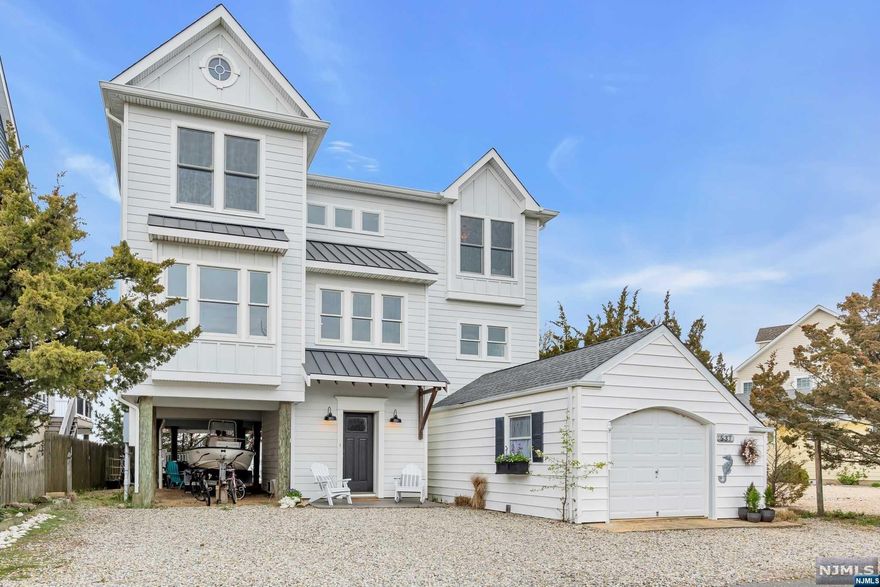 Welcome to this stunning, open bayfront home on sought-after Normandy Drive. Beautiful attention to detail at every turn in this 2018 custom build. Plenty of space for your guests with 6 bedrooms and four baths, including primary suites on the first and second floors. The main level features a modern, open floor plan for entertaining with great flow and sliders that open to a large deck overlooking the bay. Private yard with outdoor shower, covered recreation area, and 50-foot dock. Located close to the beach, Normandy Beach Yacht Club and NBIA Clubhouse and Tennis Courts. Wonderful memories are made right here - fish, crab, kayak off the dock, park your boat, enjoy the beach, or relax on the bay. It's all right here waiting for you!