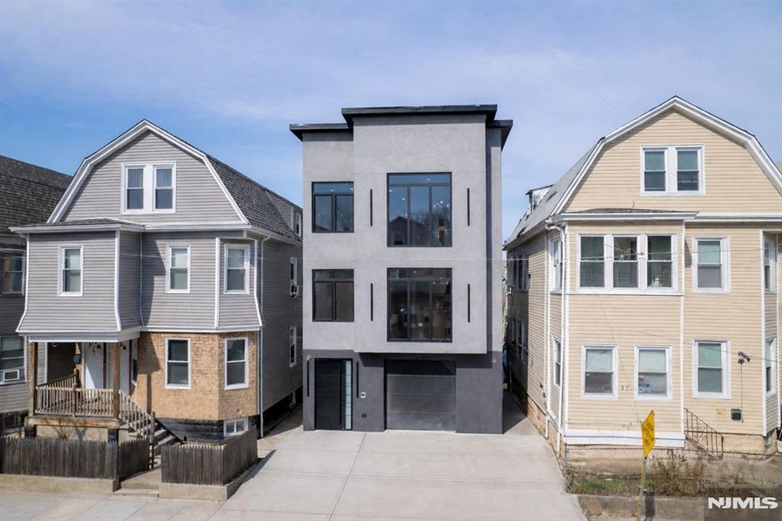 A statement of sophistication and craftsmanship, this custom new-construction two-family residence redefines modern living in Irvington, NJ. Designed with an emphasis on natural light, open flow, and contemporary elegance, every element of this home exudes refinement. From the 9-foot ceilings and gleaming hardwood floors to the European windows and designer tile-work, each detail has been curated for comfort and style. The chef's kitchen showcases quartz countertops, premium stainless-steel appliances, and a stunning center island perfect for entertaining. Step into the primary suite complete with a walk-in closet and spa-inspired bath. The versatile lower level provides ample additional living space, ideally for recreational room, media room, yoga room the options are endless, additional half bath, laundry, and access to an oversized garage. All this at a value that is truly unmatched in today's market. Incredibly low taxes and 5 year benefits apply. Conveniently located close to parks, shops, eateries, NYC commute, & so much MORE!