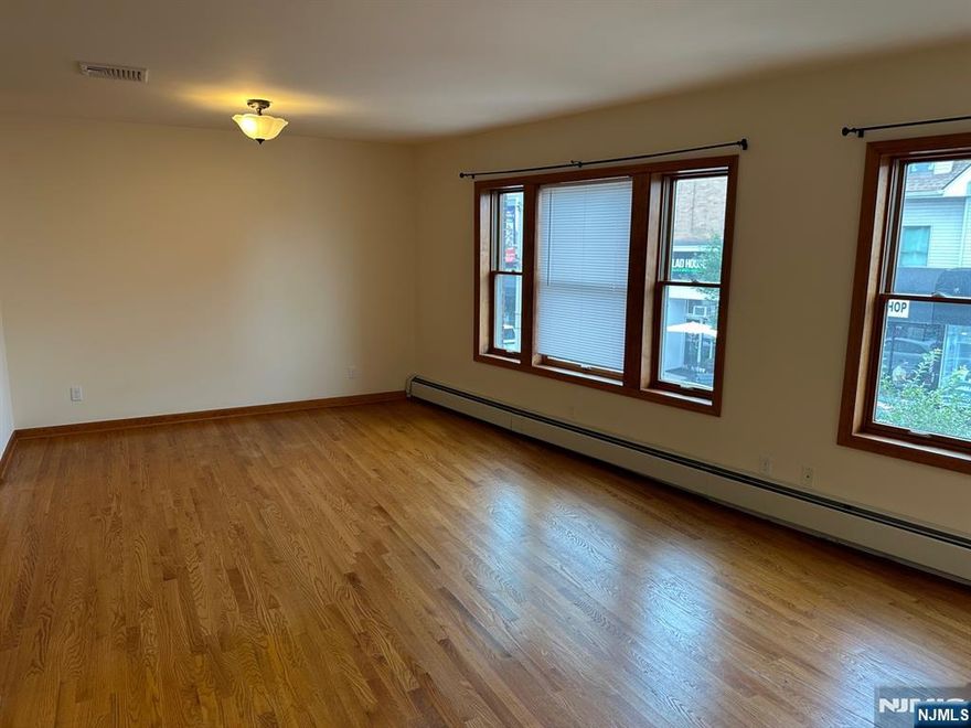 Renovated, spacious, luxury, second floor 2-bedroom 1 bath apartment in downtown Westwood with approx. 1,200 square feet. Large windows and skylights provide abundant natural light. Entire apartment freshly painted. Large living/dining room and custom kitchen with brand-new stainless-steel appliances including dishwasher, microwave, range, and refrigerator, and quartz countertops. Stacked washer and dryer in the apartment. Central air conditioning and plenty of closet space. Just refinished oak hardwood flooring throughout. Private front entrance on Westwood Ave. Two tandem parking spaces in rear parking lot. Short walk to shops, restaurants, sports club, and theater. Walking distance to train/bus terminal with easy access to NYC. Landlords insurance required. No pets and no smoking in the apartment. Tenant pays all utilities.