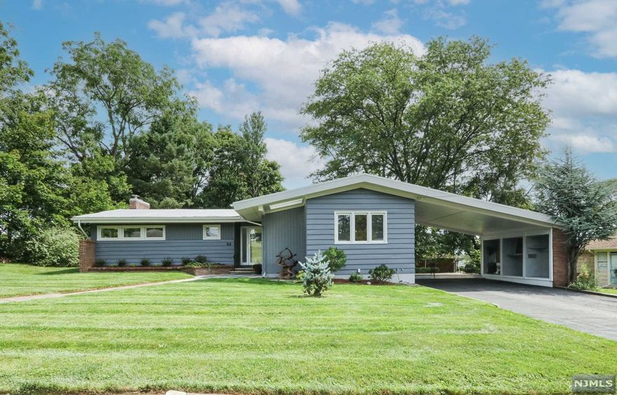 Montclair Heights Mid-Century Modern Ranch. Built in the mid-50's this 2100 Square foot home exudes period panache. Situated at the end of the road with a wooded lot next dorr it is beautful and private. The architecture of this home is stunning. The vaulted wood paneled ceiling, brick wall and wood burning fireplace, with floor to ceiling windows across the front of the oversized living room are show stopping. There is a chic newly renovated master bath with walk-in shower. The windows design in the master suite are very cool. A three season room opens to the kitchen and living room and leads to the deck. The kitchen has stainless appliances and an open dining room. Plus there are 2 additional bedroom, loads of closet space, a full bath, and a powder room. A huge basement has a spearate outside entrance. With central Ac, freshly painted inside and out,and ready to move-in. Convenient to shopping, NYC buses, and major roadways.
