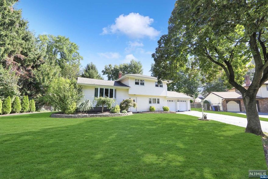 Highest and Best due by Monday Oct.10th 5:00 pm Welcome to this move in ready, spacious split level home. The entrance has tiled floors and the first and second floors have hardwood floors throughout. The ground floor offers a family room, bathroom, laundry room, an office/den, plus an oversized 2 car garage. On the first floor, you have a dining room and a large living room with a beautiful bay window. The eat-in-kitchen has stainless appliances, granite counter tops and sliding doors that lead to the deck. There is a large fenced in yard off the deck. Upstairs has 3 nice size bedrooms and a full bathroom. In the basement there is a large storage area, utility room and plenty of space for an additional family or game room. The home comes with an alarm system, sprinkler system, central air and a generator hook-up. Close to shopping, schools, house of worship and public transportation.