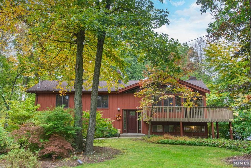 Move right in to this updated home with Mid Century design details that capture the spirit of it's era -Great Location in Lower W. Milford Newfoundland section in desirable Tall Timbers neighborhood- 1 Acre level lot with large backyard, a beautiful setting backs to wooded area. Enjoy the peaceful natural surroundings from your deck or patio or from the home's interior with gorgeous windows providing beautiful views of nature. Updates-Newly remodeled Kitchen, Newer Anderson windows 2nd flr. Newer roof over Liv Room, two bathrooms updated. Features you'll love: As you enter the living room you will be thrilled with the Vaulted, Beam ceilings & new large windows & sliding doors leading to a distinctive architectural detail- the newly refurbished Wrap-around deck on three sides! The back deck area is spacious & just off of the kitchen perfect for outdoor dining, relaxation or entertaining. Hardwood flrs. upstairs in many rooms. Lower level will impress you as well -it has a walk out