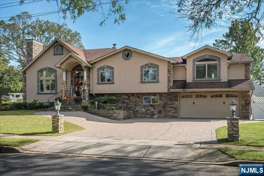 Spectacular custom home featuring a stunning stucco and stone fa ade, brick paver driveway, and walkway. The impressive two-story living room showcases a dramatic stone accent wall with fireplace, while the custom modern eat-in kitchen offers vaulted ceilings, an oversized center island, granite countertops, and top-of-the-line appliances. A formal dining room with coffered ceilings adds elegance for entertaining. The primary suite includes two walk-in closets and a luxurious spa-like bath, plus a third-level loft/office for added flexibility. The walk-out family room features a fireplace and wet bar, and the finished basement includes a dedicated laundry room. Additional highlights include recessed lighting, custom paint and trim throughout, central air, and multi-zone heating. Step outside to your own private backyard oasis complete with a covered brick paver patio, fenced heated in-ground pool with newer liner, and playground area. Fabulous location with desirable schools and just minutes to shopping, restaurants, and NJ Transit. A truly exceptional home that must be seen to be appreciated!