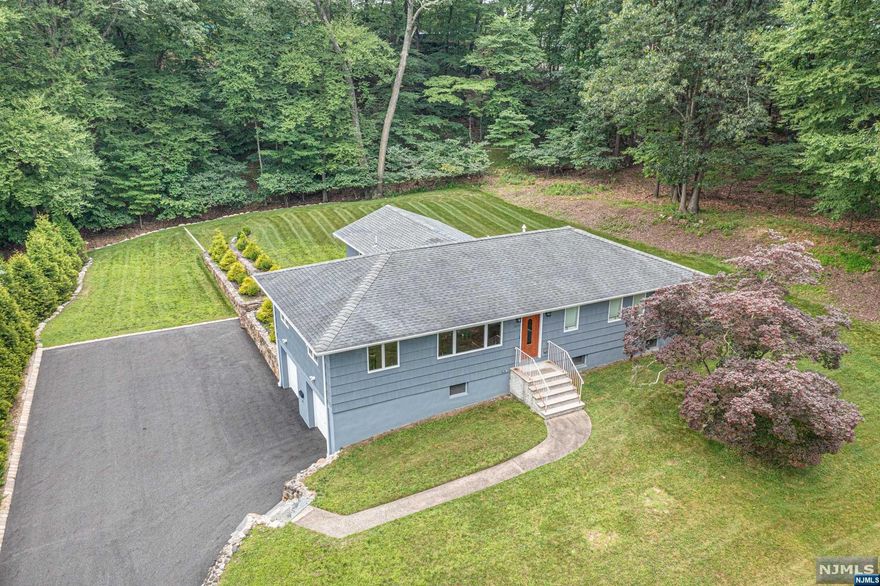 Secluded haven meticulously cared for! This stunning, fully renovated ranch located at the end of a tranquil dead-end street awaits you. The half acre+ property with lush landscaping offers ultimate privacy. The interior boasts Brazilian Cherry wood floors, ample natural light, soundproof rooms and SOLID wood doors, ensuring a serene ambiance in every room. The open floor plan flows effortlessly, perfect for entertaining guests. The chef's kitchen offers TWO ovens, granite counters, high-end SS appliances, an island with heated granite, and sliders that lead to a deck overlooking the large level, private yard. Three bathrooms boast exquisite finishes, while the primary bedroom showcases a walk-in closet and a luxurious jack-and-jill bathroom with bidet, jetted tub, and step-in shower with Kohler tower. The finished basement with full bath and storage adds versatility for a gym or office. With award-winning schools, this home and location will suit all your needs, come see!