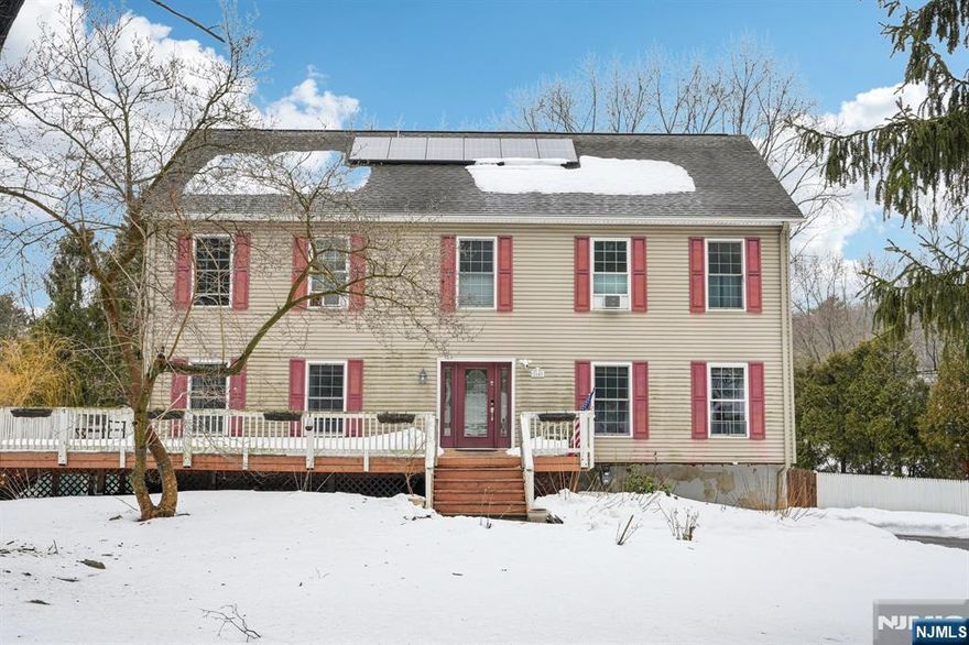 Welcome to this spacious Colonial located in the desirable Old Milford Estates section of West Milford! Set on approximately half an acre, this beautifully maintained 4-bedroom, 3.5-bath home offers the perfect blend of comfort, functionality, and space.The main level features a large eat-in kitchen with Corian countertops, center island, breakfast bar, and a sunny dining nook that opens directly to an expansive wrap-around deck perfect for entertaining or relaxing outdoors. Enjoy multiple living spaces including a formal living room, formal dining room, and a cozy family room with a fireplace.Upstairs, the generous primary suite offers a private bath and an additional flex room ideal for a home office, nursery, or sitting area. The finished basement adds incredible versatility with a full bath and separate entrance from the patio, making it ideal for guests, recreation, or extended living space.Outside, the fenced backyard is an entertainer's dream featuring an in-ground pool and plenty of room to enjoy the peaceful surroundings. Additional highlights include solar panels, a walk-up attic with potential for future finishing, a two-car garage, and ample driveway parking.A fantastic opportunity to own a spacious home in a serene setting while still being close to local amenities, parks, and commuter routes.