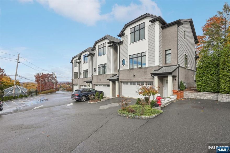 Welcome to this modern townhouse located in Ridgefield. This property offers a combination of contemporary features, convenient layout, and nearby access to major commuter routes and New York City. The main level includes an open-concept living area with high ceilings and natural light. The kitchen features stainless steel appliances, custom cabinetry, and a gas line to the patio for a grill setup. The layout is designed to accommodate everyday living as well as gatherings. The primary bedroom includes an in-suite bathroom with dual vanities, a soaking tub, and a walk-in closet. Additional bedroom offer options for guests, workspace, or flexible use with full bath. Custom closets and custom window and door treatments are installed throughout the home. Outdoor space is available for seating or dining. Additional features include a full-house generator, central vacuum system, a security system with exterior lighting, and a garage with epoxy flooring. Located minutes from major highways and the George Washington Bridge, this property offers proximity to transportation, local restaurants, shops, schools, and parks.