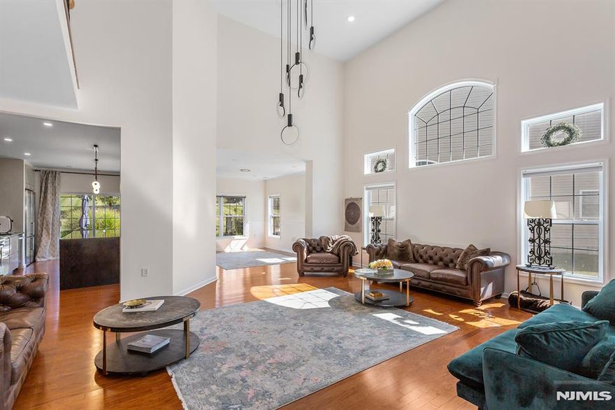 Bright, modern, and spacious 5-bedroom, 3-bath home offering 3,300 sq ft of luxurious living in the highly desirable Bluffs at Ballyowen community. This beautifully maintained 2-story brick-front residence features an open-concept layout thatâ€™s both inviting and functional. The soaring cathedral ceiling in the LR fills the space with natural light, creating a bright and elegant ambiance. At the heart of the home is a fully renovated chefâ€™s kitchen, showcasing a 10-foot quartz island with dual waterfall edges, dual deep-countertop refrigerators, sleek modern cabinetry, and a sliding glass door leading to patio, perfect for seamless indoor-outdoor entertaining. Enjoy the privacy and convenience of a 1st-floor master suite, complete with two walk-in closets. Two additional bedrooms (one is office now), a fully renovated bathroom, a formal dining room, and a laundry room complete the main level. Upstairs open loft lounge overlooks the living space and entry, accompanied by two oversized bedrooms and a 4-piece bathroom featuring heated floors. Thoughtful modern finishes enhance the homeâ€™s style and comfort throughout. Huge storage space above garage and additional easy access storage possible in the attics. Community amenities are only 40 steps away and include access to a heated saltwater outdoor pool, clubhouse with fitness center and party room. This exceptional home seamlessly blends luxury, comfort, and convenience.