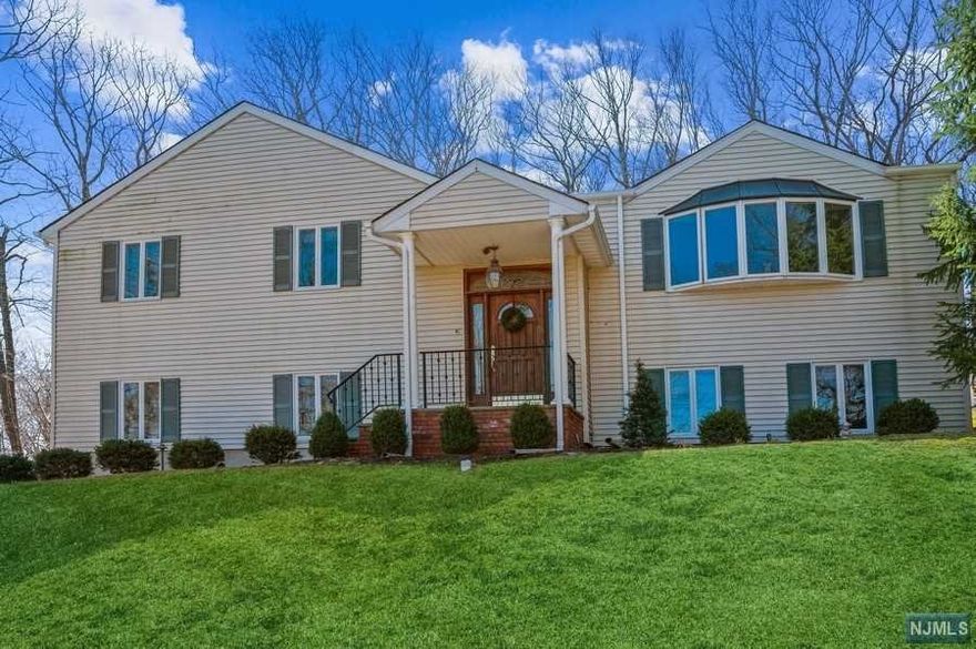 Beautifully updated and maintained Bi-Level home is situated on more than half an acre in the coveted Bradford Estates neighborhood of Morristown. This property is well located just min to downtown shops & eateries, parks, schools & Midtown NJ Direct train station. Highlights include gleaming hardwood floors, recessed lighting, crown and picture frame moldings, a stunning custom kitchen, and a sprawling stone paver patio in the private back yard that is perfect for al fresco dining, entertaining, and relaxing. Main level an open living & dining rm combination w/ 2walls of windows letting in lots of natural light. Large Eat-In kitchen featuring w/custom cabinetry, granite countertops, ss appliances. Sliding glass doors to the private, wooded patio. Primary suite with WIC & en suite Bth, 2 good size Bds, plus a hallway Bth. In the LL a Rec-Rm w/custom stone fireplace & carved oak mantel & built-in cabinets, a 4th Bd powder rm, laundry rm, and an attached 2-car garage.