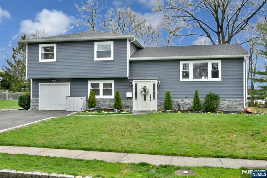 Beautifully renovated and expanded in 2023, this meticulously maintained split level home offers an open floor plan perfect for entertaining. Gleaming hardwood floors throughout. Four bedrooms with one on the ground level that offers an attached bath with shower. Expansive, flat backyard features a deck, jacuzzi and paver patio perfect for enjoying spring and summer evenings. Revel in the change of seasons while enjoying the jacuzzi or playing in the yard. The finished basement is perfect for a playroom, office, working out or watching the game.