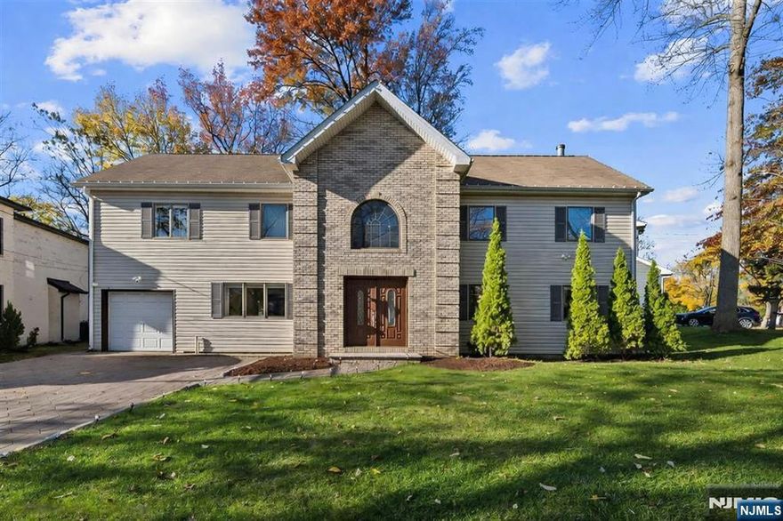 Beautiful custom Colonial on a quiet, desirable street. This spacious home offers 5 bedrooms and 3 full baths, featuring hardwood floors throughout, 2-zone heat and central air, and smart home features. The first floor includes a formal dining room, large living room with wood-burning fireplace, and a gourmet kitchen with center island, granite countertops, and stainless-steel appliances. The second floor boasts an oversized primary suite with Jacuzzi tub, separate shower, heated floors, and generous closet space. The fully fenced backyard includes a deck, paver patio, and outdoor kitchen. Additional features include a one-car garage with two-car driveway parking, in-ground sprinklers, wired internet, generator connection, washer/dryer, and all utilities included, including internet. Convenient to top-rated schools, Van Saun County Park, shopping, and major highways.