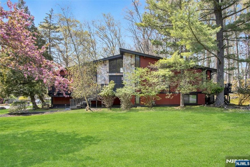 This Expansive Stone & Cedar Contemporary boasts soaring ceilings, huge rooms & open flow that blends the sophistication of Contemporary Elegance w/a high end life style. The 2 Story Custom Entry foyer opens to a Cathedral Ceiling Great Rm & Dining Rm. The Renovated Kitchen has high soaring ceilings, high end stainless appliances, granite counters, custom cabinetry & a Breakfast Rm. The Primary Suite w/architectural soaring ceilings has a private deck, W/I Closet & Primary Bath. 2 Additional Bedrooms are in the Bedroom Wing, plus a Main Bath w/high ceilings & Steam Shower. The Ground Level is another full daylight living area, w/Family Rm w/fireplace & Doors leading to a Paver Patio, an Expansive 4th Bedrm , Bath/Steam Shower, & Laundry Rm. A High Tech Summer Kitchen/Wine Cellar has a Stainless SubZero Wine Refrigerator. The cul de sac is picturesque, w/many custom homes. Enjoy an Easy nyc commute, close proximity to Lifetime Fitness, Wegmans, Trader Joes, & many fine Restaurants!