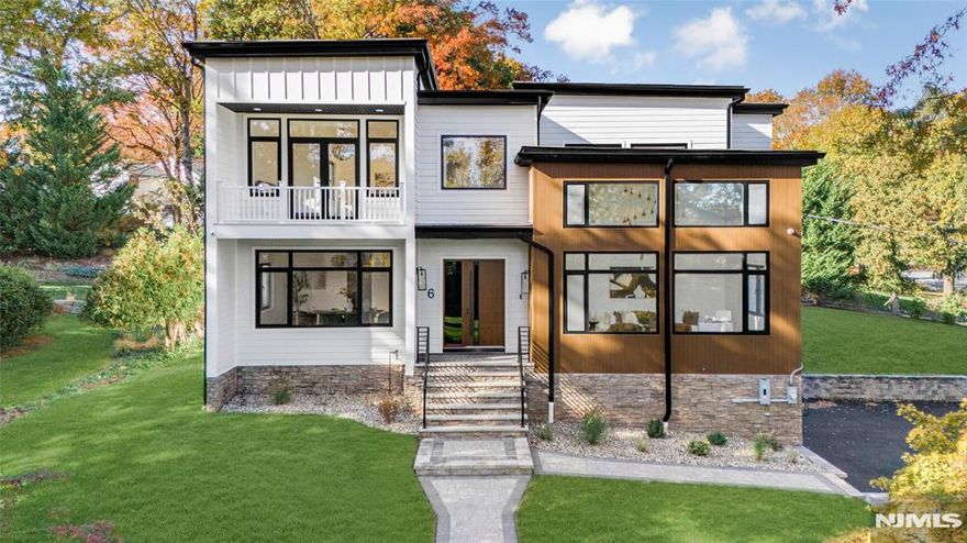 Ideally situated directly in the center of the Hartshorn school district, this newly completed transitional home captures the perfect balance of light, space and design. Spanning nearly 7,000 square feet across three levels, every room was crafted with thoughtful intention and striking detail. The grand entry opens to 10-foot ceilings and oversized windows that fill the home with natural light. The open kitchen, breakfast area and family room span the rear of the home where morning light filters through floor-to-ceiling glass. A wall of French doors leads to an expansive deck overlooking manicured grounds and mature trees. The gourmet kitchen features custom two-tone cabinetry, a full suite of Wolf and Sub-Zero appliances, a butler's pantry with a second dishwasher and beverage refrigerator, and a seamless flow to the formal dining room and living room. A first floor bedroom suite adds convenience. Upstairs, a luxurious primary suite spans the depth of the home with a private balcony, two walk-in closets, and a serene and indulgent bath. Three other spacious bedrooms on this level offer en-suite baths, while the second floor laundry center is equipped for two washers and dryers. The lower level adds a large recreation room, bedroom, full bath, powder room and ample storage. Outside, the property is surrounded by new landscaping, fresh sod and an irrigation system. An oversized two-car garage completes this exceptional residence on 0.39 acres. Be prepared to fall in love!