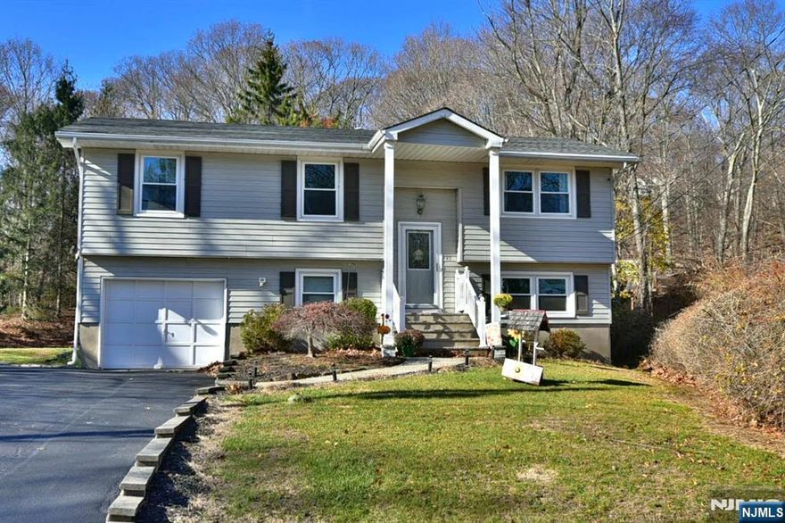 Welcome to this beautifully maintained 4-bedroom residence nestled in the sought-after Mt. Glen Lake community of lower West Milford. This move-in ready home combines modern updates with timeless charm, featuring new flooring, a recently replaced roof, and a newer septic system (2020) for peace of mind. The thoughtfully designed layout includes a spacious lower-level bedroom with a full bath and living area, offering convenience and flexibility for guests, or a private retreat. From here, enjoy direct walkouts to both the garage and the patio, leading to a generous level backyard, perfect for entertaining, gardening, or simply relaxing in your own outdoor oasis. With its prime location, updates, and inviting spaces, this home is truly must-see. Donâ€™t wait! Opportunities like this are rare, and this one wonâ€™t last long!