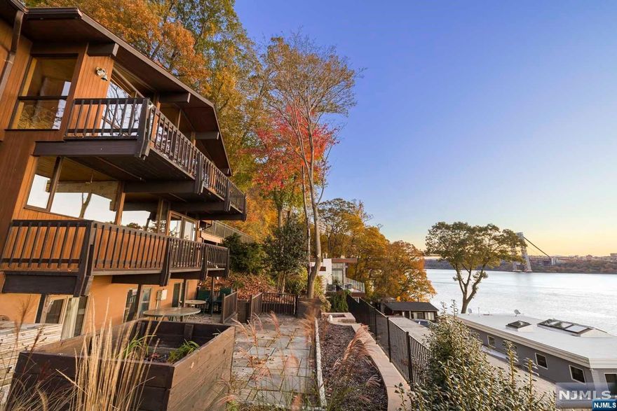 An extraordinary place that's so unique it was just featured in NJ.com for unique properties (Dec. 2023)!. Situated on a massive parcel of land w/exceptional views, this home is not to be underestimated: It borders the Palisades Park offering endless enchanting woods that one can just step right into; perfect for dog owners & nature lovers. It comes with a massive deck which embraces it all from from sunrise to sunset. A classic Mid-Century modern "deck house" has jaw dropping unobstructed views of the Hudson River, GW bridge, and NYC. Large wooden beams adorn the high ceilings w/large windows throughout & all three levels have a fireplace, views, and decks/patios. It has the feel of a ski Chalet. There's room to expand for and addition w/a possible garage too. So bring your imagination and Architect and renovate till your hearts content. This is Hudson River-front living at its best. COOP required 1% purchase price fee + 1500/1000+500. Come discover for yourself.