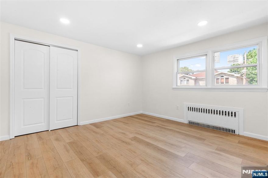 Two-bedroom unit with one newly renovated bathroom in a 2-family home. This sunny apartment includes an eat-in kitchen, generously sized bedrooms, and a comfortable living room. It also offers new flooring, fresh paint, updated windows, and new doors. Heat and hot water are included. Plenty of street parking is available. Conveniently located near shopping, parks, and just one block from NYC transportation.