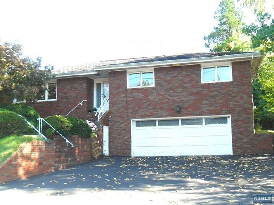 Perfect for extended family! A lot potentials for this all brick oversized ranch that offers 12 rooms! First floor showcases entry foyer, large living room, dinning room, eat-in kitchen w/skylight leading to open porch in back, master bedroom w/master bathroom, 2 sizeable bedrooms. Hardwood floor throughout. Second floor features huge attic. Large finished basement with additional 4 bonus rooms, family room, 1.5 bathrooms, laundry & utility room, 8 separate heating zones, central vacuum, plenty of storage! Attached 2-car garage and possible 4-car driveway. Great school system.