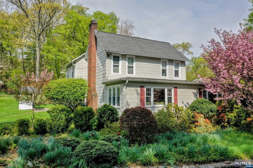 Nestled on almost 1 acre of lush gardens and wooded property, this charming farmhouse colonial is beckoning you to make it your new home. Welcome your guests to celebrate all of life's special moments and holidays in generously sized living spaces that flow seamlessly from room to room. Create culinary delights in a large kitchen while conversation abounds and wine glasses are kept full in your formal dining room. Gather to open gifts while lounging in the sunken living room. Natural light streams into the sunroom where you can relax and read a book or play a game of gin rummy. Complete with a first floor bedroom or three additional bedrooms on the second floor, makes retiring at the end of the day possible. Throw a steak on the grill as a game of football is played in the big backyard. This is your destination to set your roots and call home!