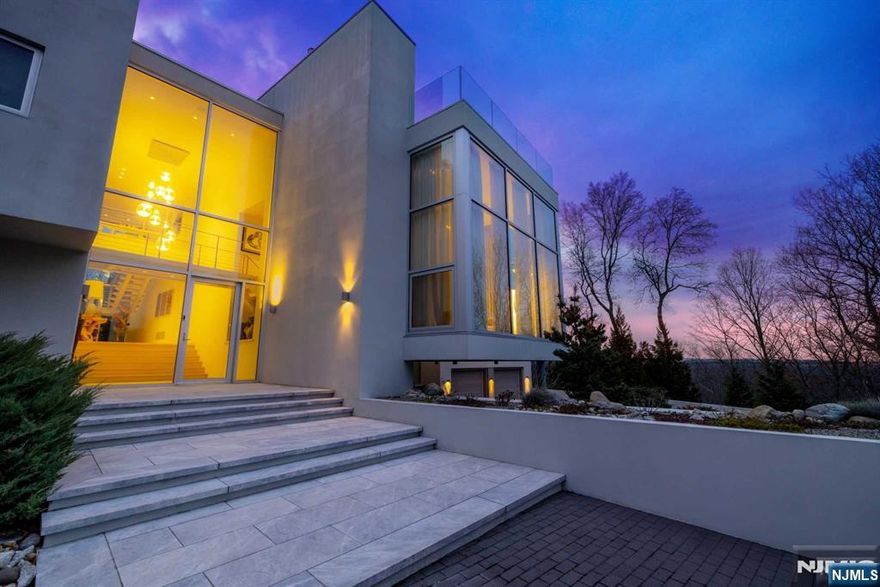 Nestled atop one of the most exclusive neighborhoods in Franklin Lakes, NJ, this architectural masterpiece offers the epitome of modern luxury and meticulous design. Set on over 3 acres of private land, this 5-bedroom, 6.5-bathroom estate boasts an array of exquisite details, including a gate monitoring system, heated floors throughout, high efficient solar panels, Geothermal heating/cooling with high efficiency gas boiler back-up, whole house humidifier/ventilation, whole house generator, Lutron house lighting control, SONOS sound system, a state-of-the-art gym, wine cellar, infinity-edge saltwater pool, outdoor BBQ/kitchen, car port with carwash, commercial grade roofing. Surrounded by a nature preserve, this property offers the ultimate in privacy and serenity, all while being just 30 minutes from NYC. This is a must-see property for those seeking the very best in luxury living.