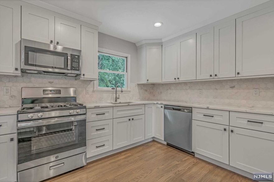 This newly renovated MOVE IN READY home is located on a cul-de-sac in one of the most desirable neighborhoods in Ho-Ho-Kus. The first floor features an open layout with a large living room with wood-burning fireplace, dining room, well-appointed brand new eat-in kitchen complete with white cabinetry, quartz countertops and stainless steel appliances that opens to a spacious deck perfect for outdoor entertaining. Upstairs offers 3 bedrooms including Master bedroom with new modern bathroom and new hall bathroom. The lower levels include a family room, updated powder room, laundry and large finished basement perfect for a playroom or rec room. Convenient to NYC transportation, top-rated schools and downtown. Just unpack your bags and enjoy everything this freshly updated home has to offer!