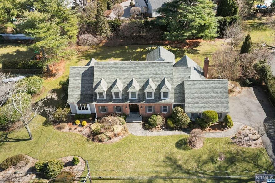 Pristine 29-year-young center hall colonial w/ new roof, situated on a quiet cul-de-sac in a premier Wyckoff neighborhood. A freshly painted and landscaped exterior welcomes you to a grand 2-story entry foyer leading to an open concept main level. Superior flow throughout the stunning interior with an eat-in kitchen overlooking a spacious great room with a fireplace at the heart of the home, formal living and dining rooms, and mudroom/laundry with a convenient entrance from the 2-car attached garage. Also tucked away on the main level are a home office and an expansive primary suite with 2 walk-in closets, immaculate full bath, and don't miss the NEW three season porch. Second floor has 3 spacious bedrooms with the potential to convert to 4 bedrooms, a full bath, and attic space over the garage that presents expansion opportunities. Private backyard offers a newer deck, flat property and gas grill/prep area. Ultimate location, close to schools and great commute options to NYC.